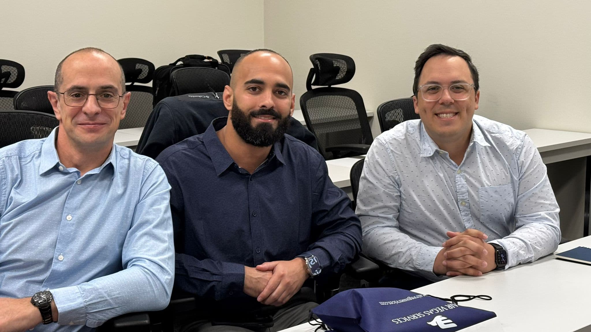 Three AVS graduates seated together after completing their program
